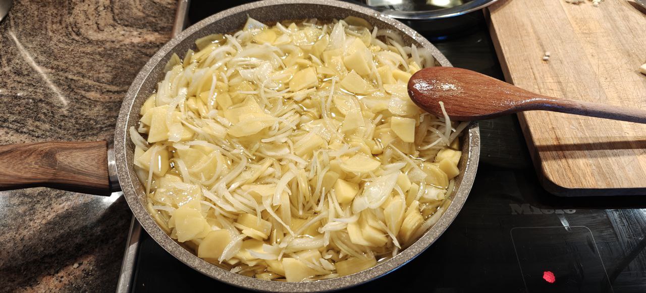 the potatoes and the onions into the pan